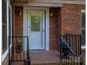 Close-up of the front entrance showcasing a decorative glass door, brick surround, and a 'Welcome' mat at 211 W Tennessee Ave, Bessemer City, NC 28016