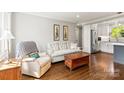 Inviting living room with hardwood floors and soft, natural light flowing through the windows at 241 Wakefield Dr # C, Charlotte, NC 28209