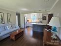 Cozy living room with hardwood floors that connect to a bright, modern kitchen at 241 Wakefield Dr # C, Charlotte, NC 28209