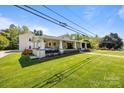 Well-maintained home featuring a large front yard and cozy covered porch at 3008 Gantt St, Salisbury, NC 28146