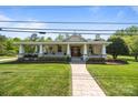Inviting home with a covered porch, lush lawn, and stone walkway leading to the front door at 3008 Gantt St, Salisbury, NC 28146