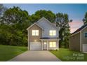 Charming two-story home with a well-manicured lawn and attached garage at 3048 Goble St, Gastonia, NC 28056