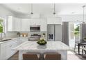 Modern kitchen featuring white cabinets, stainless steel appliances, and marble countertops at 3048 Goble St, Gastonia, NC 28056