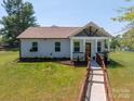 Charming home showcasing a covered porch and landscaped front yard at 3121 Suffolk Dr, Shelby, NC 28152