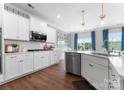 Bright, modern kitchen features stainless steel appliances, white cabinets, and a subway tile backsplash at 3619 Slider Ter, Lancaster, SC 29720