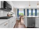 Well-lit kitchen offers stainless steel appliances, white cabinets, and a large window overlooking backyard at 3619 Slider Ter, Lancaster, SC 29720