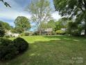 Large, verdant backyard with mature trees, offering a peaceful outdoor setting at 404 S Mulberry St, Cherryville, NC 28021
