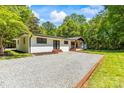 View of the brick home from the driveway surrounded by lush green grass at 4110 Charles Raper Jonas Hwy, Alexis, NC 28006