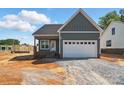 New construction exterior featuring a two-car garage and board and batten details at 424 Fulton Dr, Kings Mountain, NC 28086