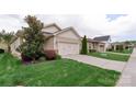 Charming home featuring a two-car garage, well-manicured lawn, and beautiful landscaping at 4991 Looking Glass Trl, Denver, NC 28037