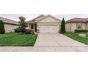 Charming home featuring a two-car garage, well-manicured lawn, and beautiful landscaping at 4991 Looking Glass Trl, Denver, NC 28037