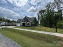 Gray home with a sidewalk along the lawn, in an undeveloped neighborhood at 5006 Mclaughlin Dr # 103, Waxhaw, NC 28173
