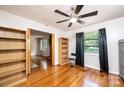 Bedroom with wood floors, ceiling fan, and views to another room and the outside at 542 9Th Nw St, Hickory, NC 28601