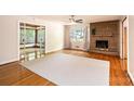 Spacious living room featuring hardwood floors, large windows, and a stone fireplace at 542 9Th Nw St, Hickory, NC 28601