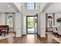 Bright foyer featuring hardwood floors, grand columns, and an open view to the front yard at 9217 Rock Water Ct, Waxhaw, NC 28173