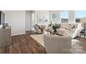Comfortable living room with wood floors, neutral colors, and cozy seating arrangement at 1034 Mapletree Ln, Indian Trail, NC 28079