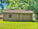 Detached one car garage and out-building nestled in a serene, tree-lined backyard at 127 Edgeway Rd, Mooresville, NC 28117