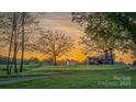 Scenic property with a barn and outbuildings, framed by mature trees, perfect for nature lovers at 153 Coachman Loop, Statesville, NC 28625