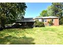 Spacious backyard featuring a covered patio and ample green space at 17389 Mooresville Rd, Mooresville, NC 28115