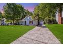 A well-maintained home with a long driveway leading to a detached garage at 1938 Dembrigh Ln, Charlotte, NC 28262