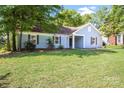 Cozy home showcasing blue siding, dark shutters, and a lovely front yard at 1938 Dembrigh Ln, Charlotte, NC 28262