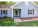 Inviting front entrance with a covered porch, columns, and a dark-colored front door at 1938 Dembrigh Ln, Charlotte, NC 28262