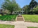 Two-story brick home with well-manicured front yard and mature trees at 2018 Radcliffe Ave, Charlotte, NC 28207