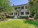 Traditional brick home with black shutters, landscaping, and an American flag at 2018 Radcliffe Ave, Charlotte, NC 28207