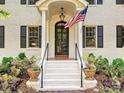 Inviting front entrance with a black door, American flag, and decorative planters at 2018 Radcliffe Ave, Charlotte, NC 28207