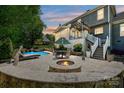 Private backyard oasis with pool, fire pit, waterfall and stone surround at 205 Commodore Ct, Belmont, NC 28012