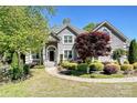 Charming home with a landscaped yard, circular walkway, and inviting entrance at 205 Commodore Ct, Belmont, NC 28012