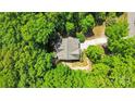Aerial view showcasing the home surrounded by lush, mature trees and a private lot at 2417 Labelle Dr, Waxhaw, NC 28173