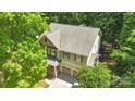Aerial view of a two-story home with a two car garage, lush trees, and a large roof at 2417 Labelle Dr, Waxhaw, NC 28173