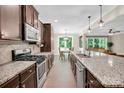 Modern kitchen features stainless steel appliances, granite countertops, and an open floor plan at 2417 Labelle Dr, Waxhaw, NC 28173
