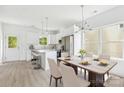 Modern kitchen with sleek white cabinetry, stainless steel appliances, and a dining area at 3056 Goble St, Gastonia, NC 28056