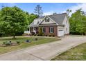 Beautiful brick and vinyl home featuring a manicured lawn and attached two-car garage at 3179 Westview Rd, Concord, NC 28025