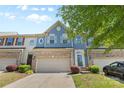 Charming townhome showcasing a blue facade, brick accents, and a well-maintained front yard at 3245 Major Samuals Way, Charlotte, NC 28208