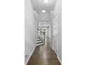 Inviting hallway with hardwood floors leading to a staircase and bright living space at 3245 Major Samuals Way, Charlotte, NC 28208