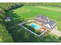 Aerial view of a gorgeous home with fenced in pool surrounded by green lawns and countryside at 3300 Paul Heavner Ln, Lincolnton, NC 28092