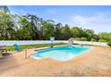 Backyard swimming pool with diving board, lounge area, and lush landscaping at 3300 Paul Heavner Ln, Lincolnton, NC 28092