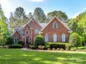 Beautiful brick home with manicured lawn and landscaping at 3519 Weddington Oaks Dr, Matthews, NC 28104