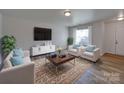 Bright living room with stylish furnishings, a patterned rug, and modern decor for a welcoming space at 4018 Larkhaven Village Dr, Charlotte, NC 28215