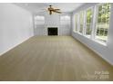 Spacious living room featuring a fireplace with built-in shelves and large windows for natural light at 4035 Caldwell Ridge Pkwy, Charlotte, NC 28213
