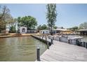 Picturesque waterfront property with a boat dock, inviting views, and a charming home at 451 S Strand Dr, Norwood, NC 28128
