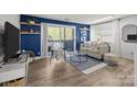 Comfortable living room showcasing a balcony, stylish decor, and an inviting seating arrangement at 505 N Graham St # 2H, Charlotte, NC 28202