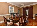 Formal dining room featuring hardwood floors, elegant chairs, and chandelier lighting at 505 S South St, Gastonia, NC 28052