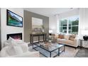 Bright living room with a fireplace, comfortable seating, and large windows with scenic views at 5116 Fireweed Ct, Dallas, NC 28034