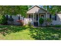 Inviting single-Gathering home featuring a cozy front porch, lush landscaping, and charming curb appeal at 5184 Swinging Bridge Rd, Conover, NC 28613