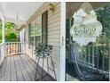 Inviting covered front porch with stylish decor and a glimpse of the home's exterior at 5184 Swinging Bridge Rd, Conover, NC 28613