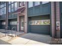 Townhome with attached garage and street access, featuring covered entry and brick facade at 562 New Bern Station Ct, Charlotte, NC 28209